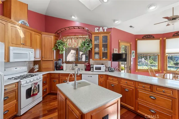 a kitchen with stainless steel appliances granite countertop a sink a stove and a refrigerator