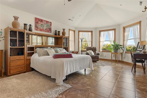 a bedroom with furniture and a flat screen tv