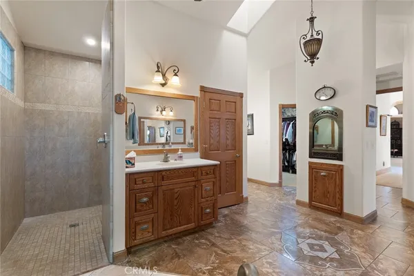 a spacious bathroom with a tub sink and mirror