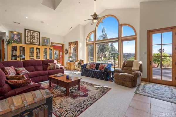 a living room with furniture a rug and a large window