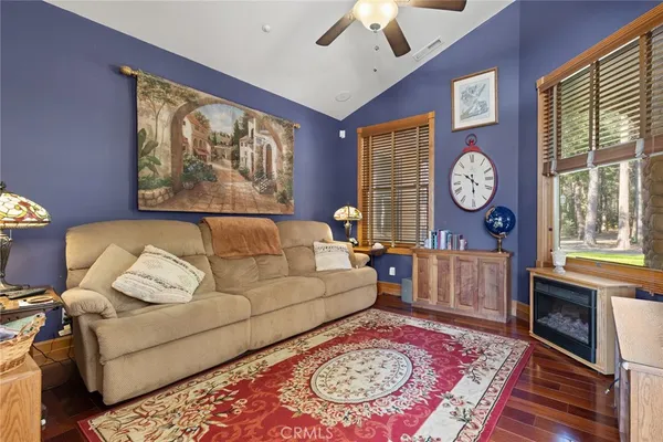 a living room with furniture a fireplace and a large window