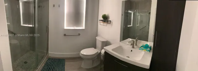a bathroom with a sink toilet and shower