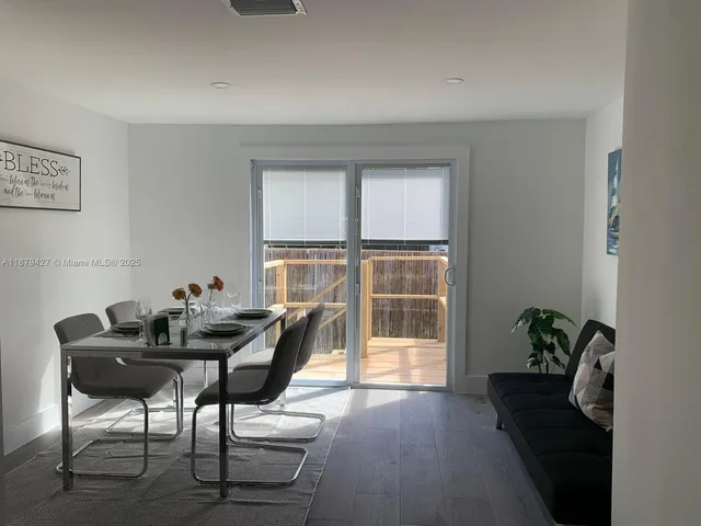 a view of a workspace with furniture and a potted plant