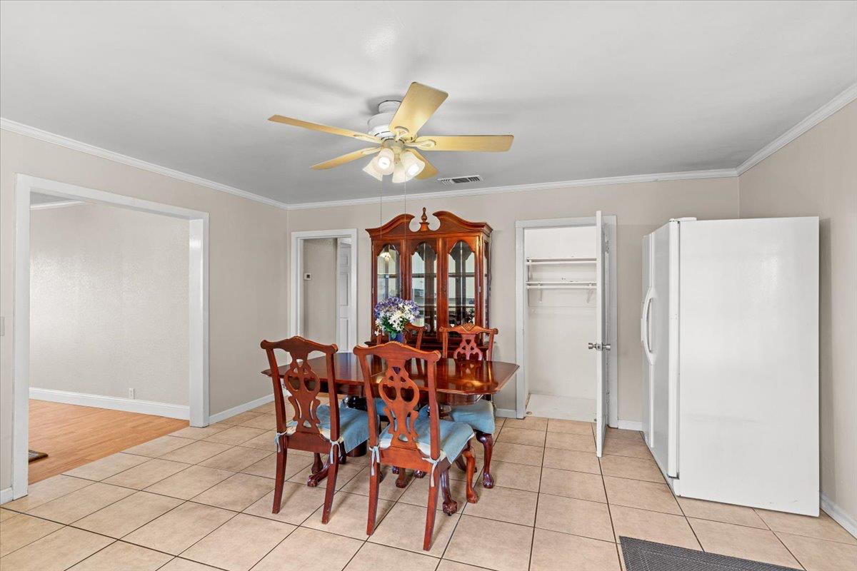 607 East Keyes Road Ceres, CA 95307 - Photo 12 of 46 dining room featuring ceiling fan, crown molding, and light tile patterned flooring