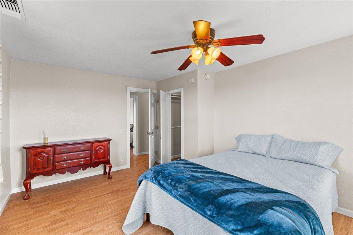 607 East Keyes Road Ceres, CA 95307 - Photo 14 of 46 bedroom featuring light wood-style floors, a spacious closet, and a ceiling fan