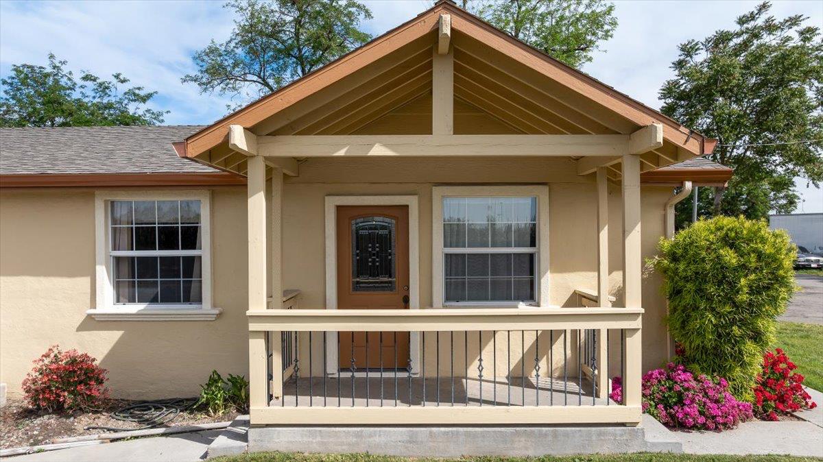 607 East Keyes Road Ceres, CA 95307 - Photo 15 of 46 doorway to property with stucco siding, roof with shingles, and a porch