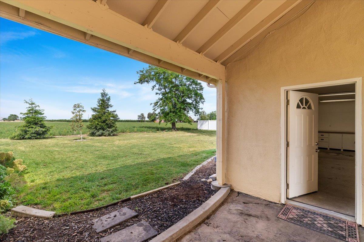 607 East Keyes Road Ceres, CA 95307 - Photo 19 of 46 view of grassy yard with a patio and a rural view