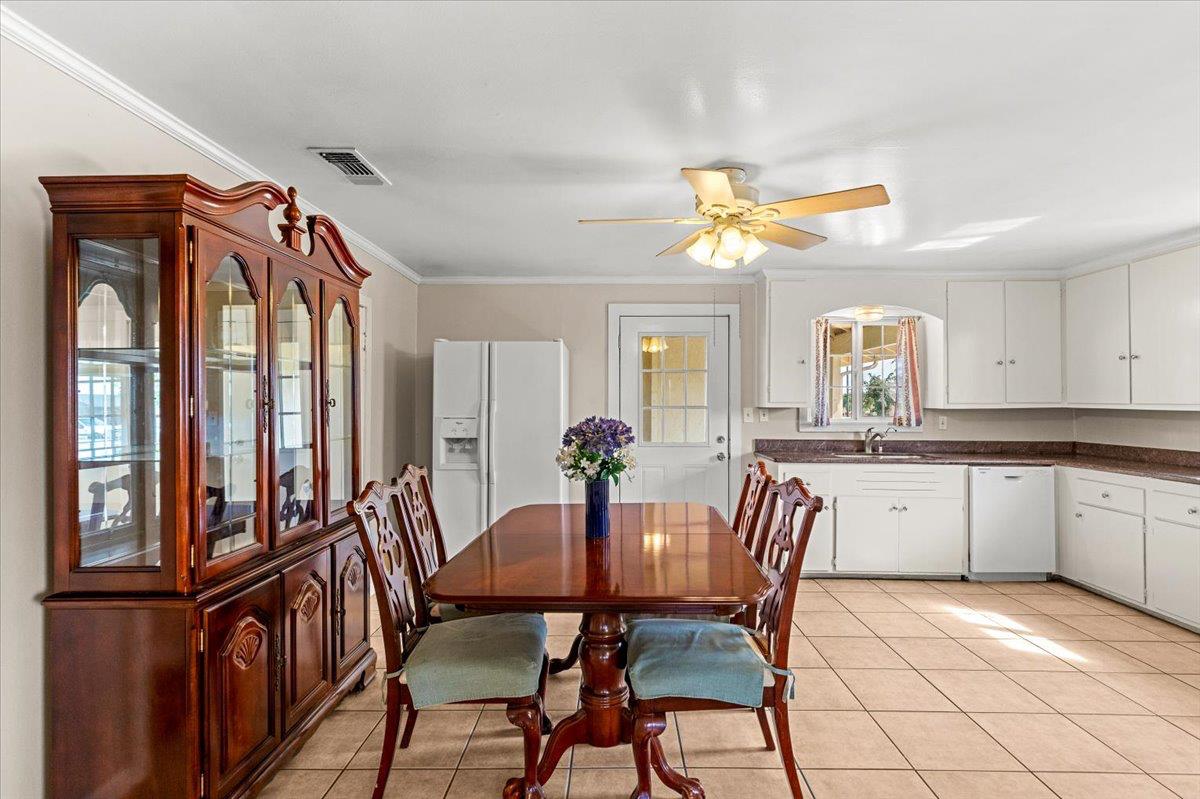 607 East Keyes Road Ceres, CA 95307 - Photo 22 of 46 dining room with ornamental molding, a ceiling fan, and light tile patterned flooring