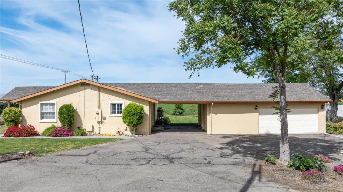 607 East Keyes Road Ceres, CA 95307 - Photo 24 of 46 ranch-style home featuring stucco siding, an attached garage, a shingled roof, and driveway
