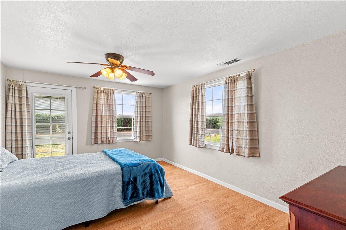607 East Keyes Road Ceres, CA 95307 - Photo 26 of 46 bedroom featuring wood finished floors, ceiling fan, and a textured ceiling