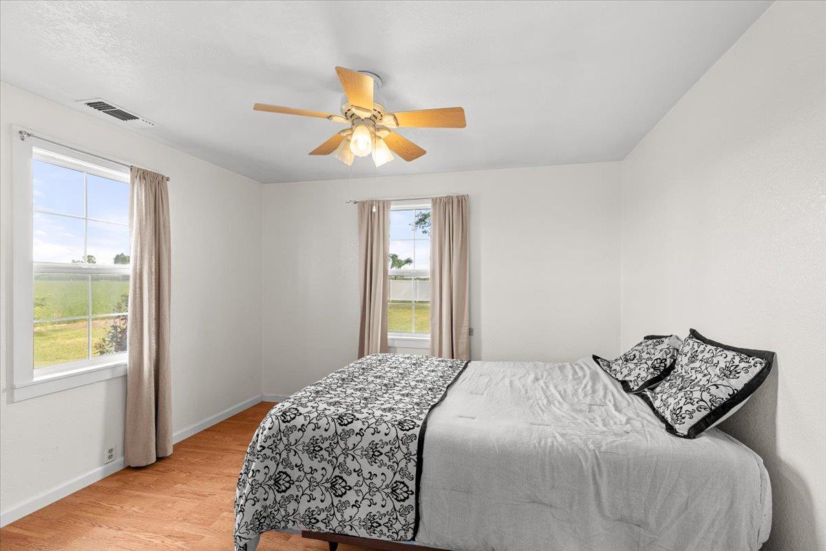 607 East Keyes Road Ceres, CA 95307 - Photo 30 of 46 bedroom with light wood-type flooring and ceiling fan