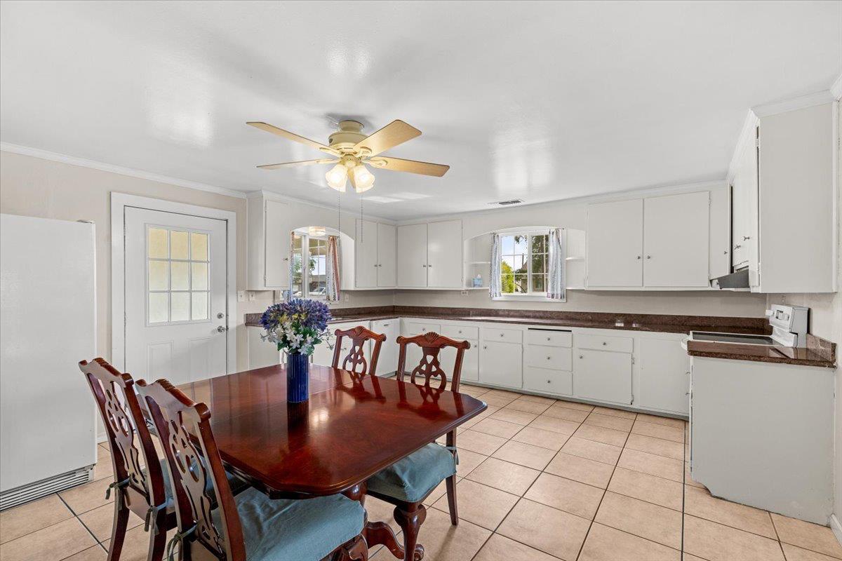 607 East Keyes Road Ceres, CA 95307 - Photo 3 of 46 dining area featuring ornamental molding, light tile patterned flooring, and ceiling fan