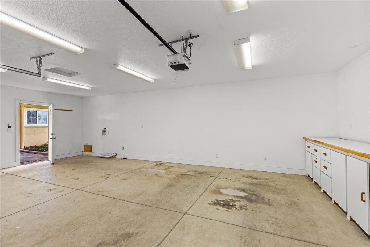 607 East Keyes Road Ceres, CA 95307 - Photo 32 of 46 garage featuring baseboards and a garage door opener