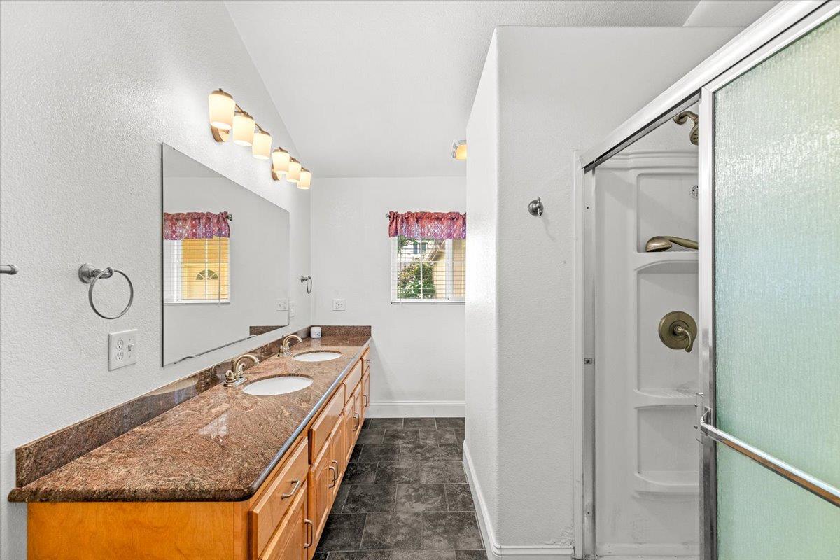 607 East Keyes Road Ceres, CA 95307 - Photo 37 of 46 full bathroom with double vanity and a stall shower