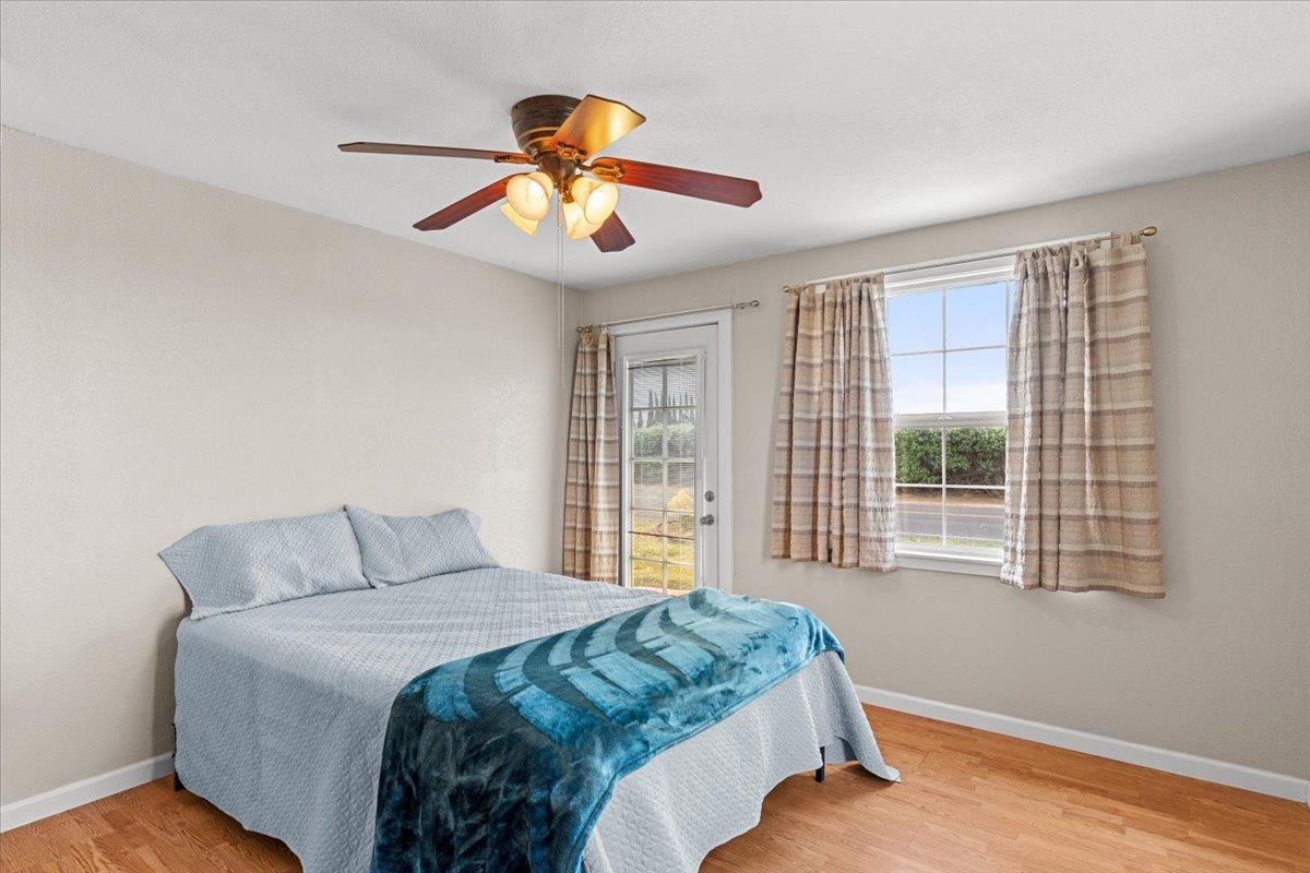 607 East Keyes Road Ceres, CA 95307 - Photo 43 of 46 bedroom with light wood finished floors, access to exterior, and a ceiling fan