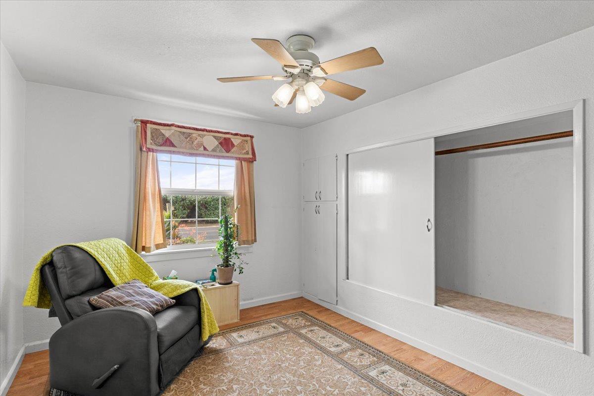 607 East Keyes Road Ceres, CA 95307 - Photo 9 of 46 Bedroom featuring light wood-style floors and a ceiling fan and vintage closets