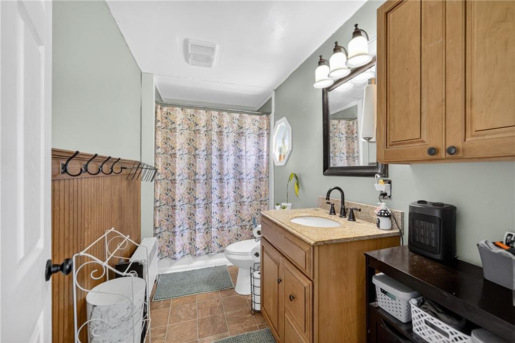 3879 Pittsburgh Road Perryopolis, PA 15473 - Photo 13 of 32 a bathroom with a sink and a mirror