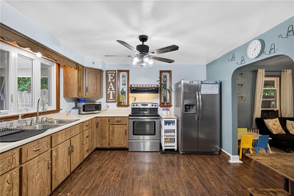 3879 Pittsburgh Road Perryopolis, PA 15473 - Photo 3 of 32 a kitchen with stainless steel appliances granite countertop a refrigerator a stove and a sink