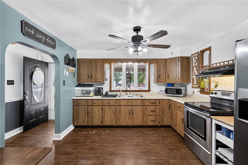 3879 Pittsburgh Road Perryopolis, PA 15473 - Photo 4 of 32 a large kitchen with stainless steel appliances granite countertop a stove and a sink