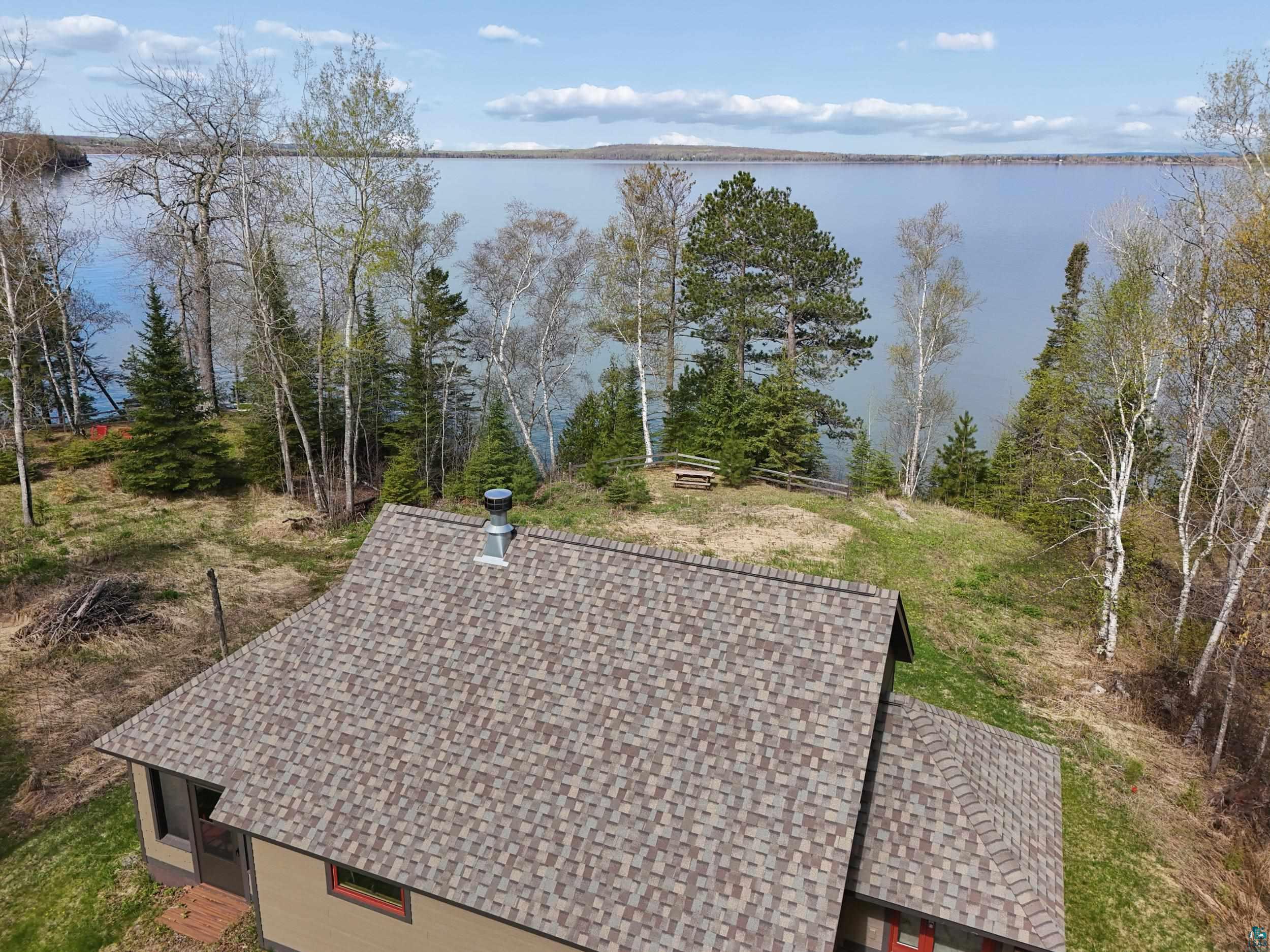 89095 West Romans Point Road Herbster, WI 54844 - Photo 7 of 30 Lakefront property featuring a pitched roof, shingle siding, and mature trees