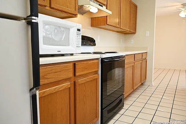 a kitchen with stainless steel appliances granite countertop a sink and cabinets