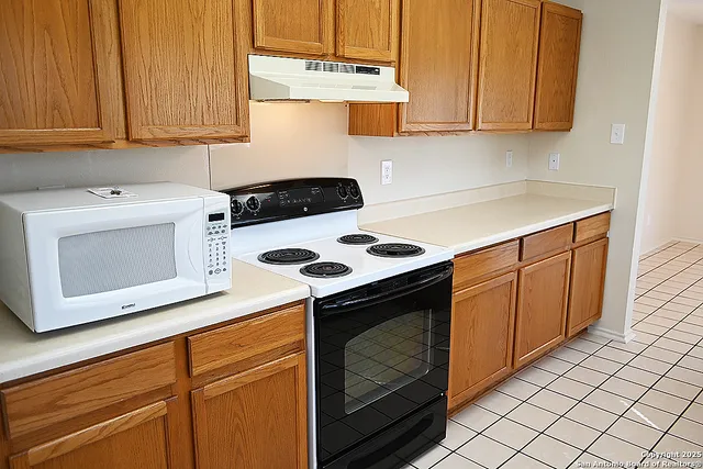 a kitchen with a stove and a microwave