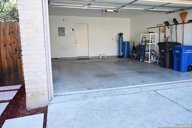 a view of backyard with table and chairs and wooden fence