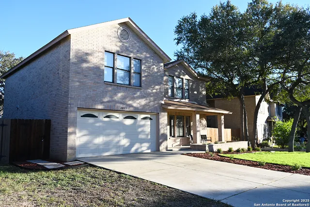 a view of a house with a backyard