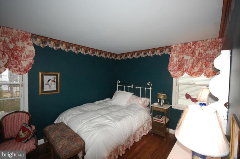 3209 Northbrook Road Pikesville, MD 21208 - Photo 11 of 13 a bedroom with a bed and a painting on the wall