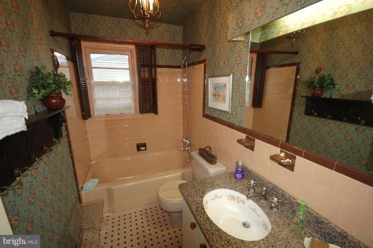 3209 Northbrook Road Pikesville, MD 21208 - Photo 12 of 13 a bathroom with a sink a toilet and shower