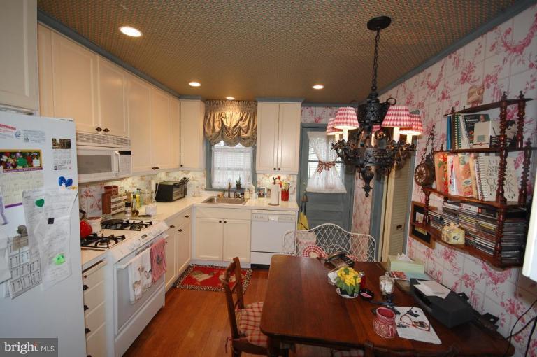 3209 Northbrook Road Pikesville, MD 21208 - Photo 4 of 13 a kitchen with stainless steel appliances kitchen island granite countertop a sink cabinets and refrigerator