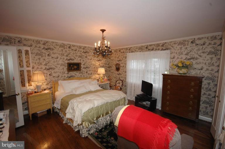 3209 Northbrook Road Pikesville, MD 21208 - Photo 10 of 13 a bed room with a bed and a fireplace