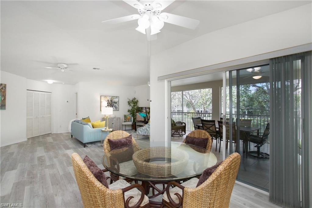 700 Diamond Circle, Unit 706 Naples, FL 34110 - Photo 14 of 37 a living room with furniture and a large window