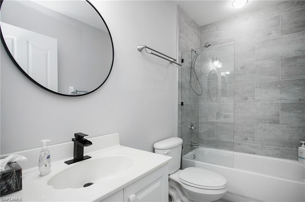 700 Diamond Circle, Unit 706 Naples, FL 34110 - Photo 16 of 37 a bathroom with a sink a toilet and shower