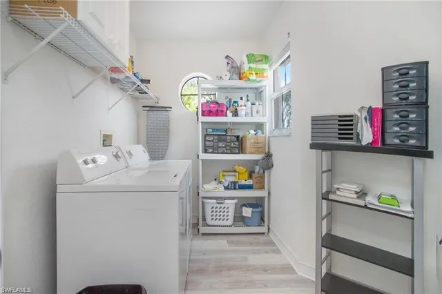 a utility room with fridge dryer and washer
