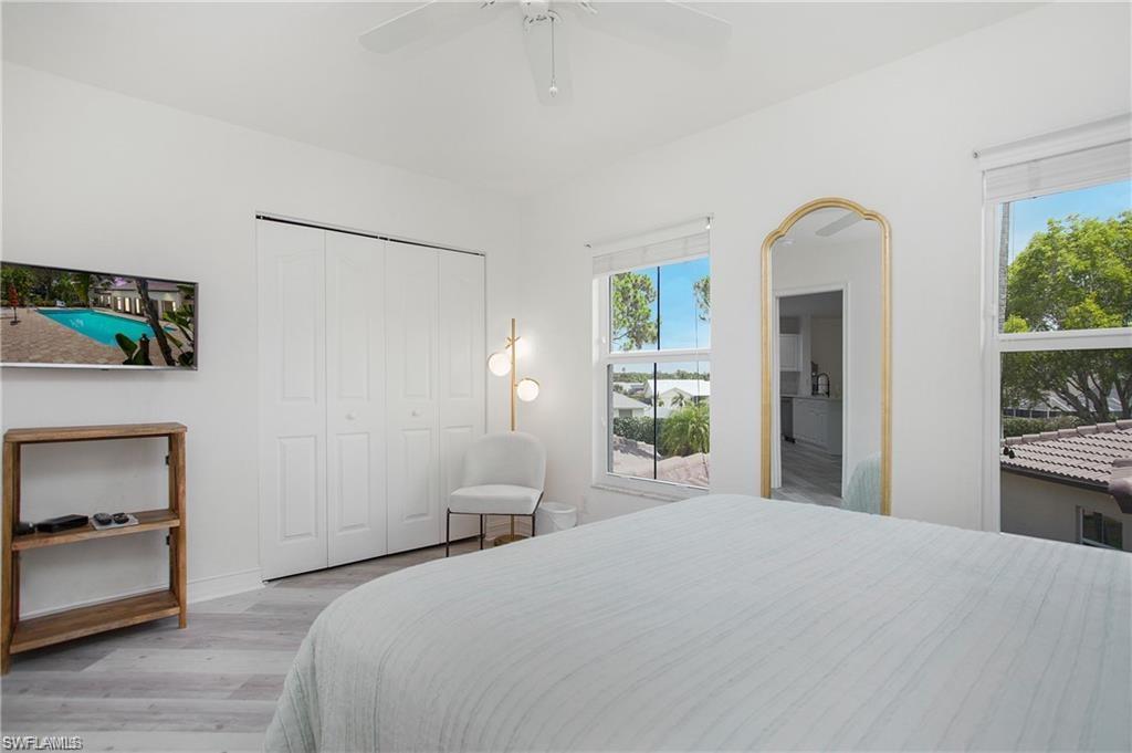 700 Diamond Circle, Unit 706 Naples, FL 34110 - Photo 20 of 37 a bedroom with a bed and a dresser