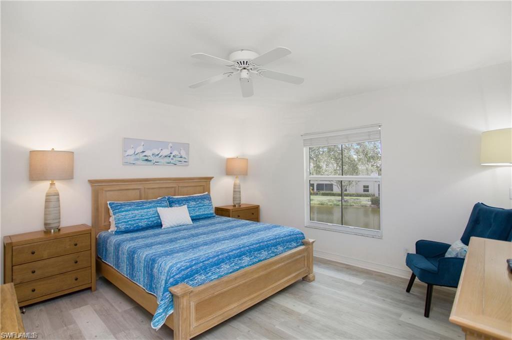 700 Diamond Circle, Unit 706 Naples, FL 34110 - Photo 21 of 37 a bedroom with a bed and a chair