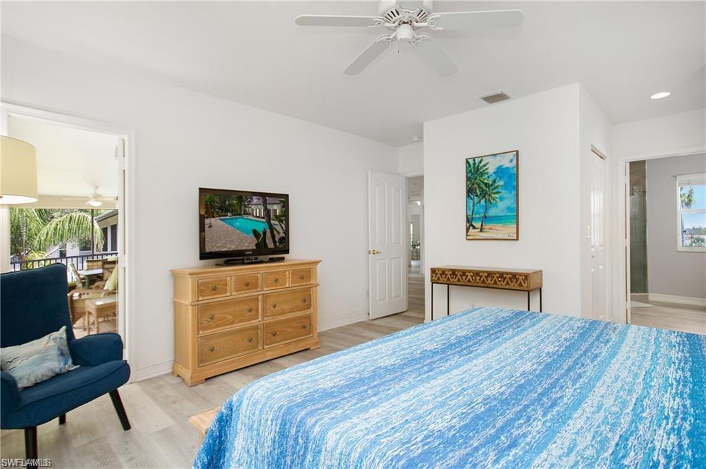 700 Diamond Circle, Unit 706 Naples, FL 34110 - Photo 22 of 37 a bedroom with a bed and a dresser in it
