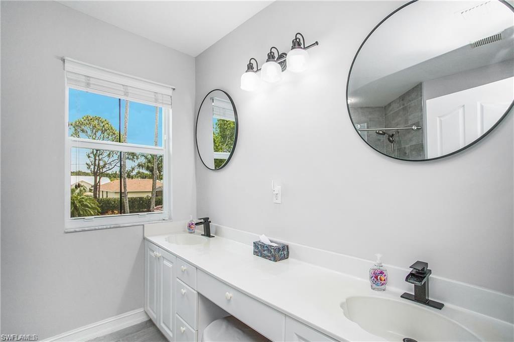 700 Diamond Circle, Unit 706 Naples, FL 34110 - Photo 24 of 37 a bathroom with a sink and a mirror