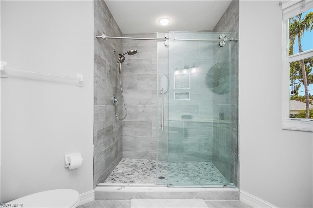 700 Diamond Circle, Unit 706 Naples, FL 34110 - Photo 25 of 37 a bathroom with a shower and toilet