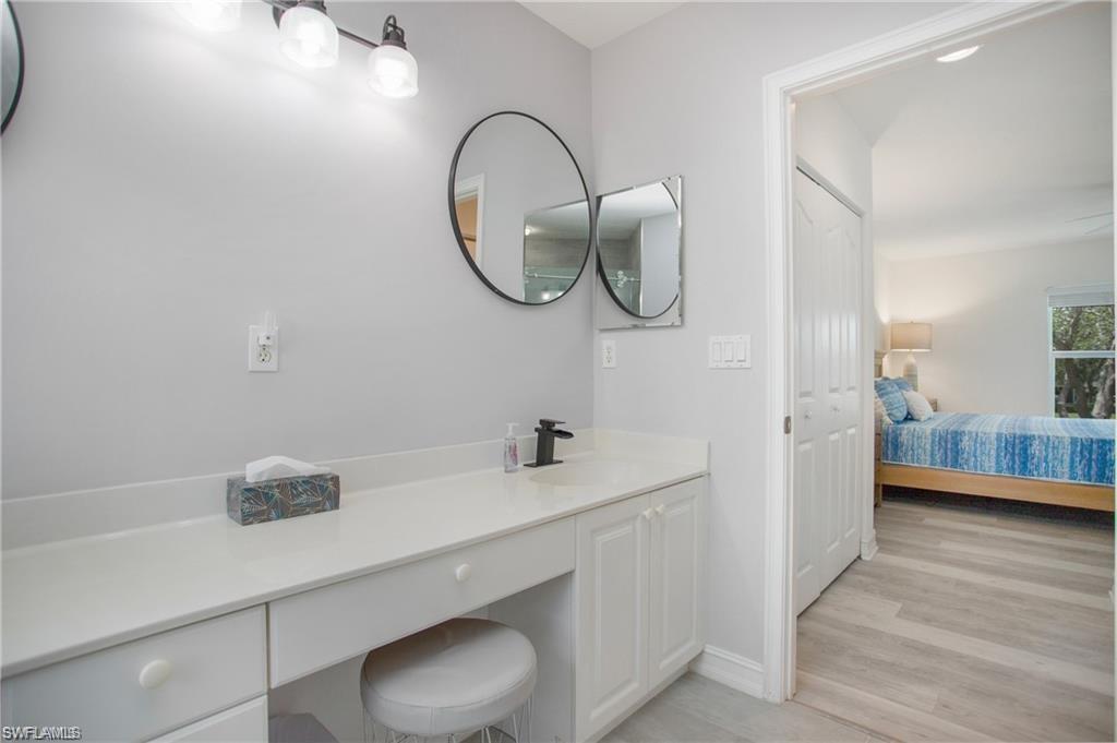 700 Diamond Circle, Unit 706 Naples, FL 34110 - Photo 26 of 37 a bathroom with a sink and a mirror