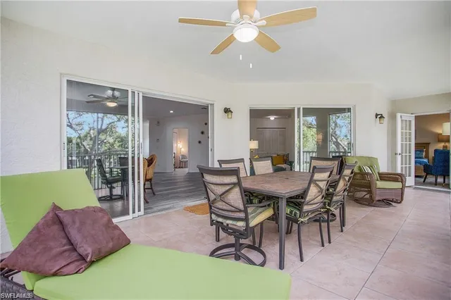 a view of a dining room with furniture and a chandelier