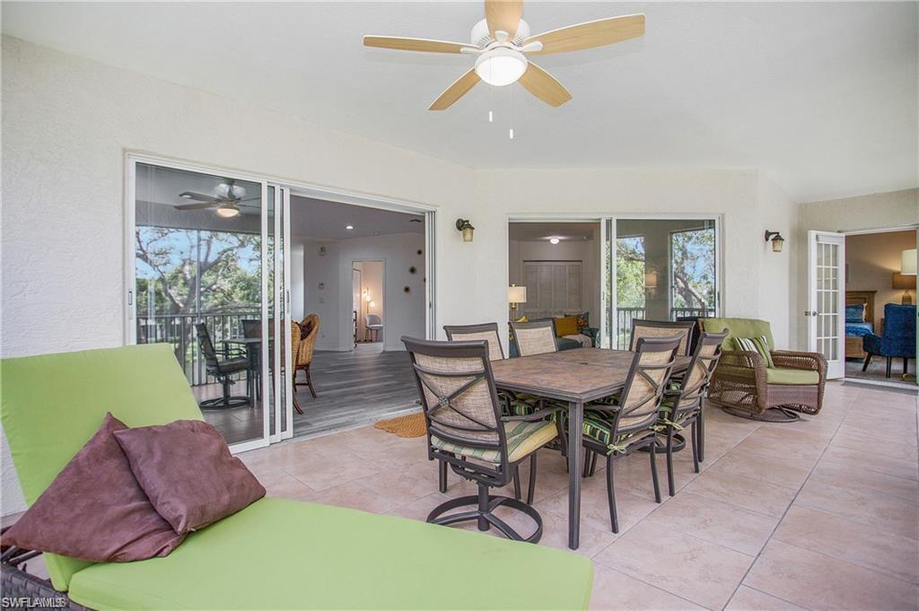 700 Diamond Circle, Unit 706 Naples, FL 34110 - Photo 29 of 37 a view of a dining room with furniture and a chandelier