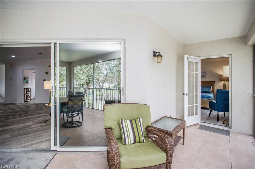 700 Diamond Circle, Unit 706 Naples, FL 34110 - Photo 31 of 37 a living room with furniture and a floor to ceiling window