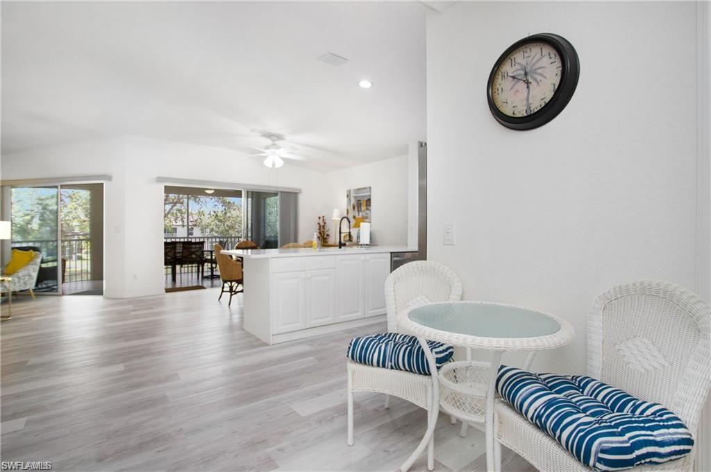 700 Diamond Circle, Unit 706 Naples, FL 34110 - Photo 5 of 37 a living room with furniture and a wooden floor