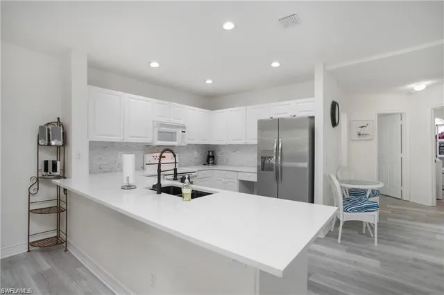 a kitchen with stainless steel appliances a sink stove and refrigerator