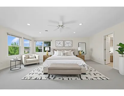 a bedroom with furniture and a large window