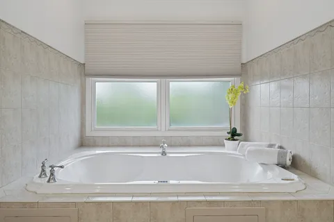 a bathroom with a bathtub and window