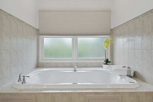 a bathroom with a bathtub and window