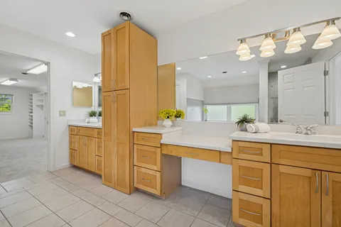 a bathroom with a sink a faucet a mirror and a bathtub